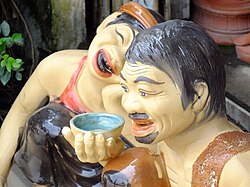Vietnamese statues depicting the traditional practice of teeth blackening (nhuộm răng đen)