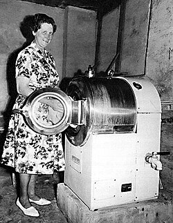 A housewife by a Wascator laundry machine