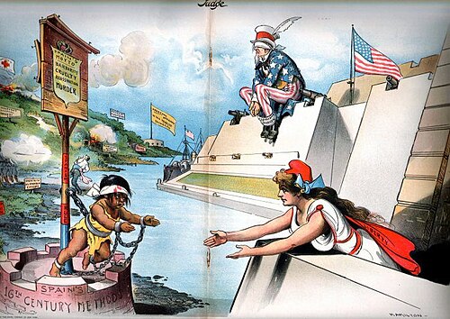 Columbia (the American people) reaches out to help oppressed Cuba in 1897 while Uncle Sam (the U.S. government) is blind to the crisis and will not use its powerful guns to help. Judge magazine, February 6, 1897.