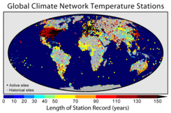 Map of the land-based long-term monitoring stations included in the Global Historical Climatology Network. Colors indicate the length of the temperature record available at each site.