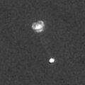 Camera on Mars orbiter snaps Phoenix suspended from its parachute during descent through Mars's atmosphere.
