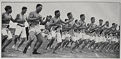 B&W photo of men dancing, chanting