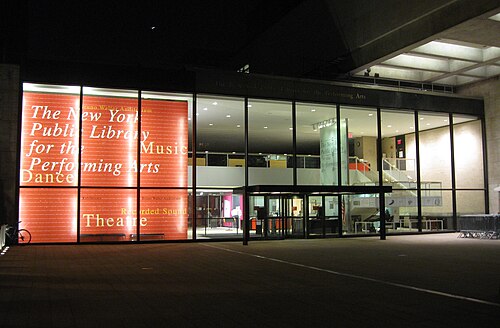 The New York Public Library for the Performing Arts' entrance from Lincoln Center Plaza at night