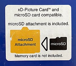 Sticker on an Olympus FE-370 box showing the camera is compatible with xD cards and the included microSD adapter. Olympus abandoned this approach, as well as the xD card format, one year later