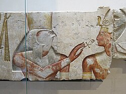 Horus offers life (symbolized by an Ankh) to the pharaoh, Ramesses II. Painted limestone. c. 1275 BCE, 19th dynasty. From the small temple built by Ramses II in Abydos, Louvre museum, Paris, France.