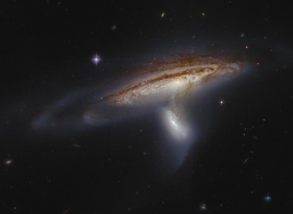 Figure 1: Tidal interaction between the spiral galaxy NGC 169 and a smaller companion[1]