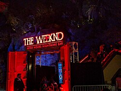 A night photograph of the entrance to the Weeknd's haunted house during Universal's Halloween Horror Nights, sported in red.