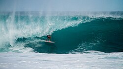 Surfer getting tubed at Sunset on the North Shore of Oahu